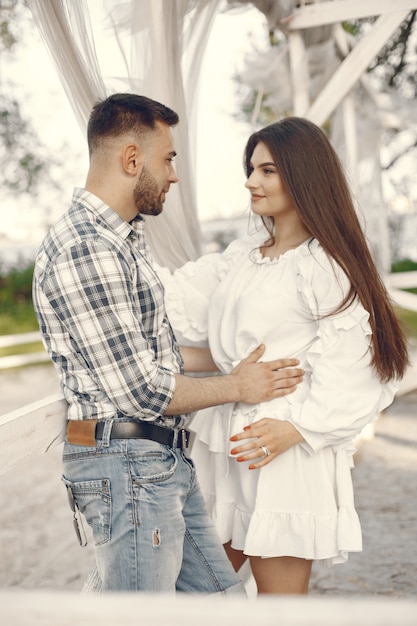 Beautiful couple spend time in a summer park