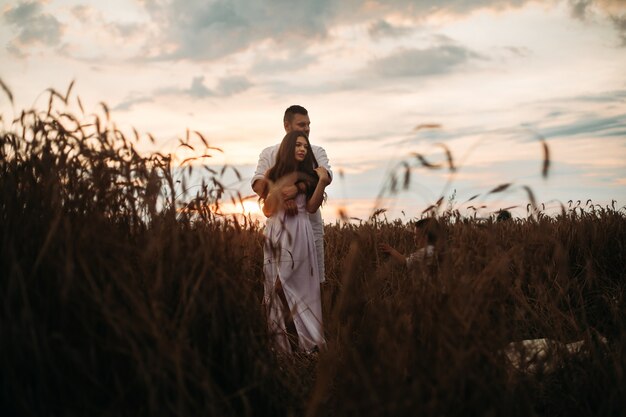 Beautiful couple standing in the field.