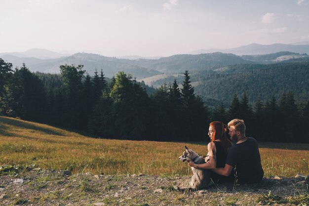 Beautiful couple standing on a hill and looks into the distance