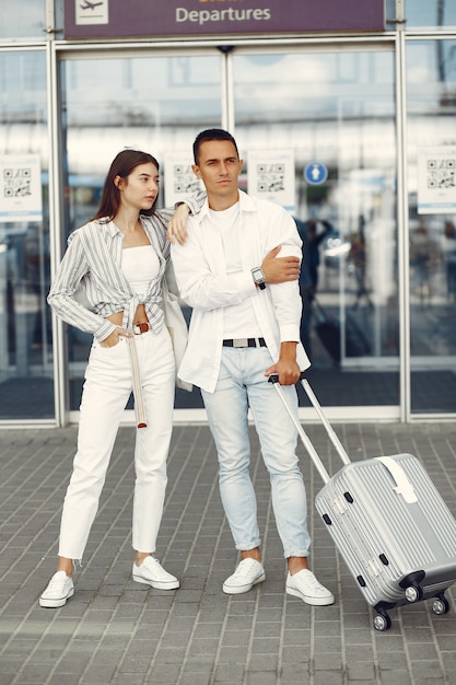 Beautiful couple standing near the airport