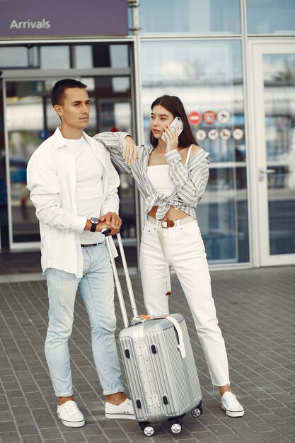 Beautiful couple standing near the airport