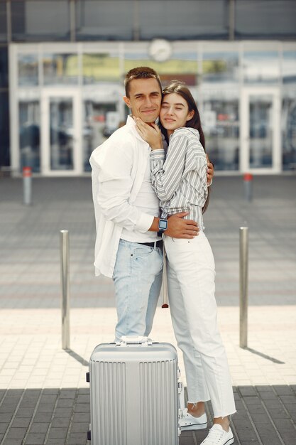 Beautiful couple standing near the airport