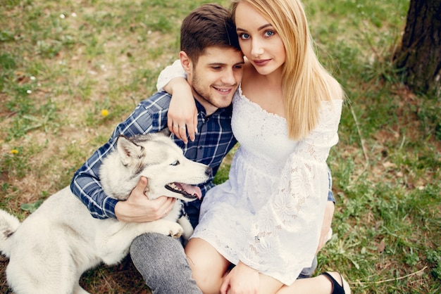 Free photo beautiful couple in a summer forest with a dogs