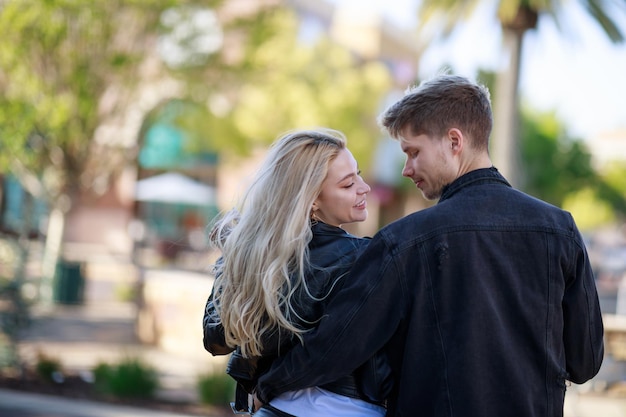 A beautiful couple turned their back to the camera and looking at each others