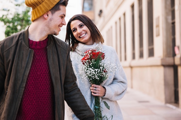 Beautiful couple walking down street