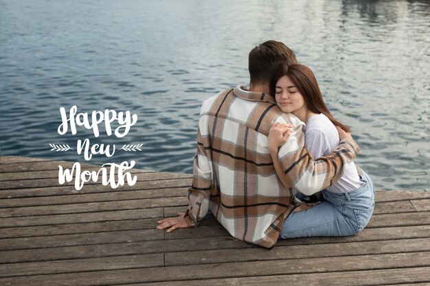 Free photo beautiful couple with happy new month lettering