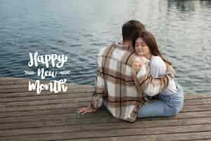 Free photo beautiful couple with happy new month lettering