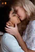 Free photo beautiful couple of women kissing on the lips