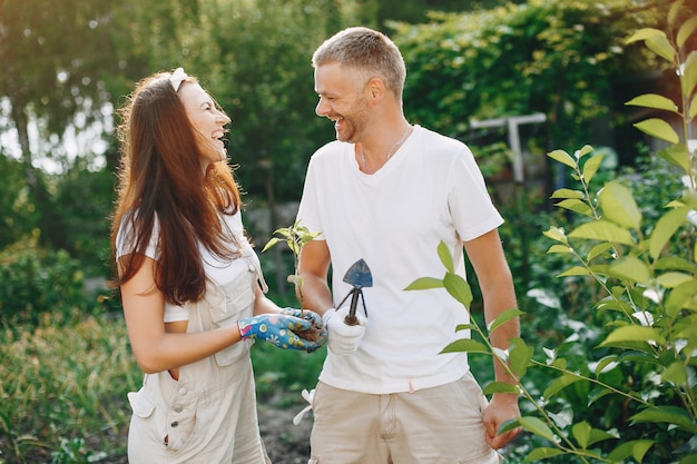 Beautiful couple works in a garden 