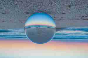 Free photo beautiful creative shot of a beach with a crystal lens ball