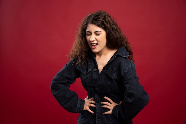 Beautiful curly woman feeling pain in her stomach.