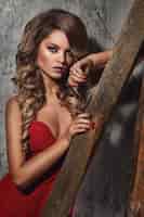 Free photo beautiful curly woman in red dress