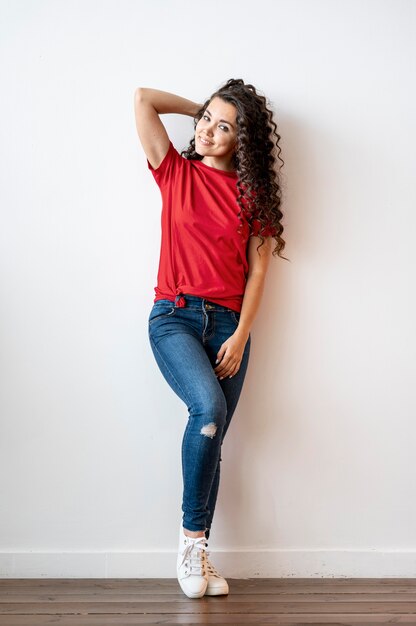 Beautiful curly woman in red t-shirt posing