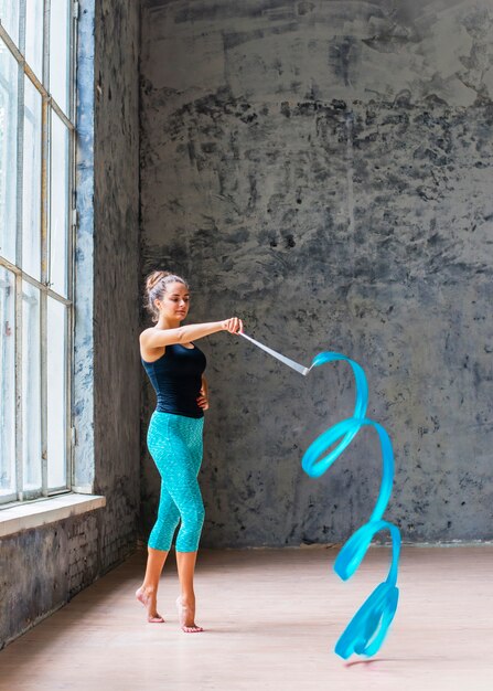 Beautiful dancer dancing with blue ribbon