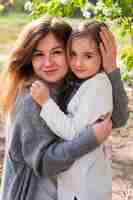 Free photo beautiful daughter and mother posing