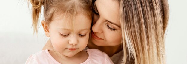 Beautiful daughter and mother spending time together at home