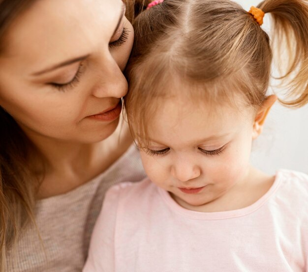 Beautiful daughter and mother spending time together at home