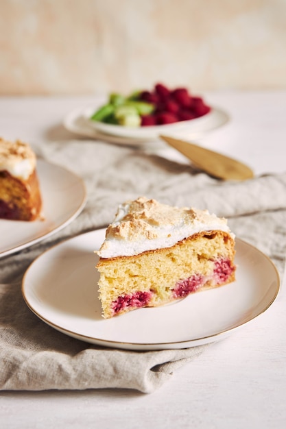 Beautiful and delicious raspberry and rhubarb cake with ingredients on a table