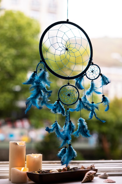 Beautiful dream catcher and candles outdoors