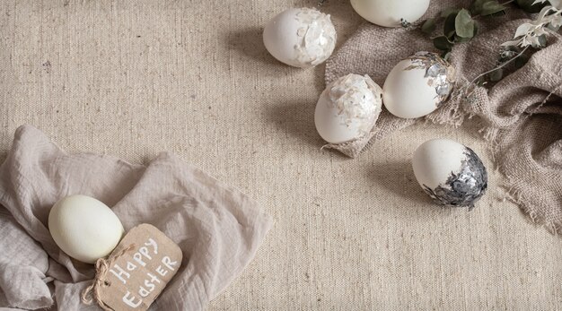 Beautiful Easter eggs scattered on the textured fabric. Easter decor concept.