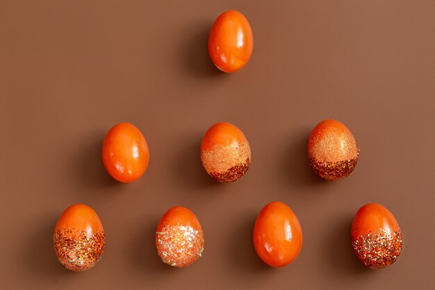 Beautiful Easter with orange decorative eggs in spangles.