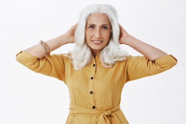 Beautiful elegant elderly woman looking pleased with haircut