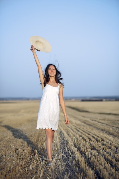 Beautiful elegant girl in a autumn wheat field