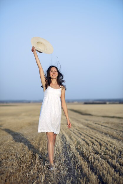 Beautiful elegant girl in a autumn wheat field