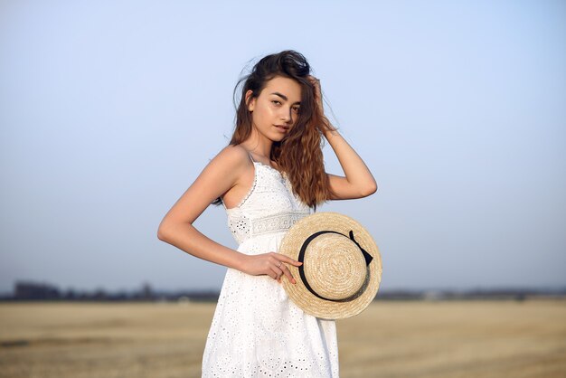 Beautiful elegant girl in a autumn wheat field