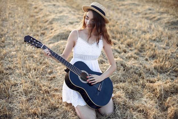 Beautiful elegant girl in a autumn wheat field