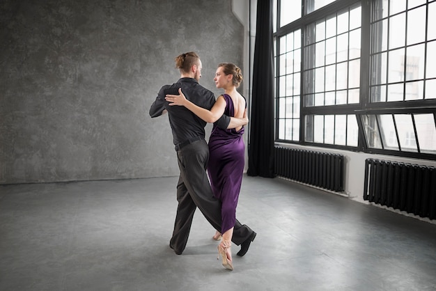 Free photo beautiful elegant people dancing tango