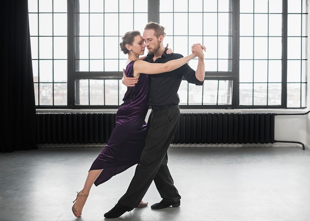 Free photo beautiful elegant people dancing tango