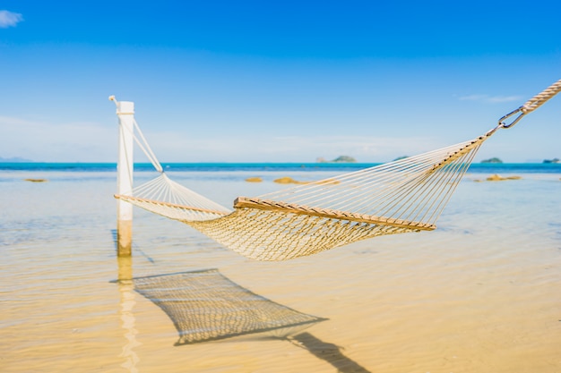 Beautiful empty hammock around tropical beach sea ocean for holiday vacation