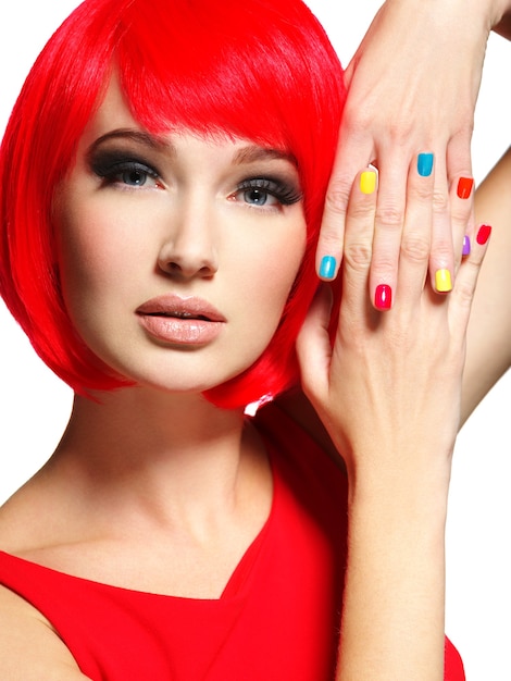 Free photo beautiful face of a girl with stylish multicolor nails.