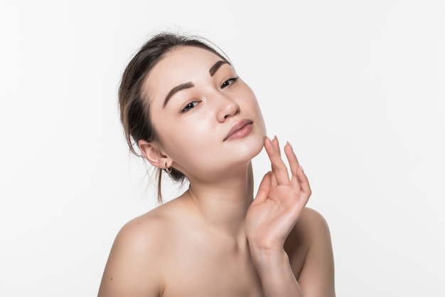 Beautiful face of a young woman with clean fresh skin isolated on white wall. Skincare and body care concept.