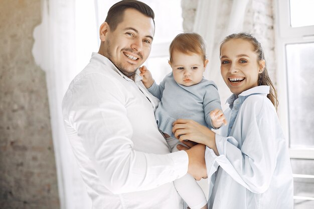 Beautiful family spend time in a bedroom