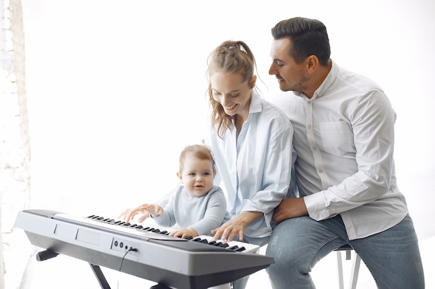 Beautiful family spend time in a music studio