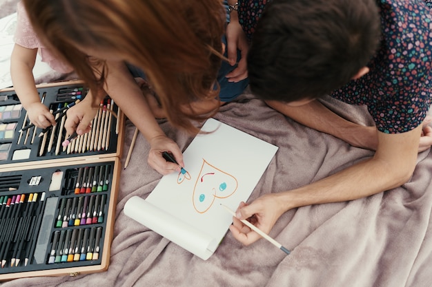 Beautiful family spends time together, drawing