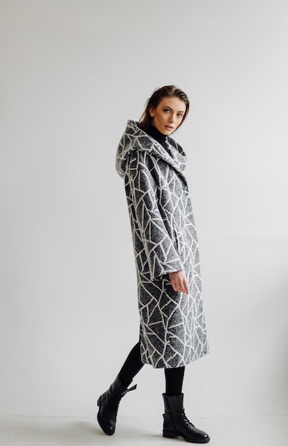 Beautiful fashion woman posing with elegant coat