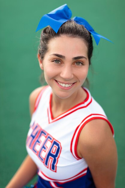Beautiful female cheerleader in cute uniform