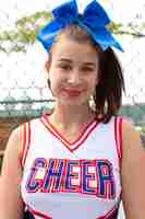 Free photo beautiful female cheerleader in cute uniform