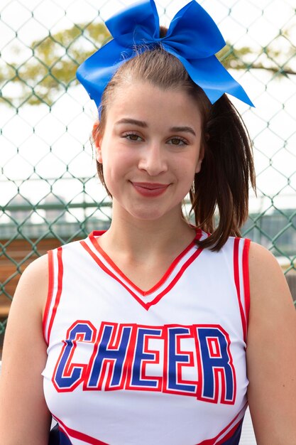 Beautiful female cheerleader in cute uniform