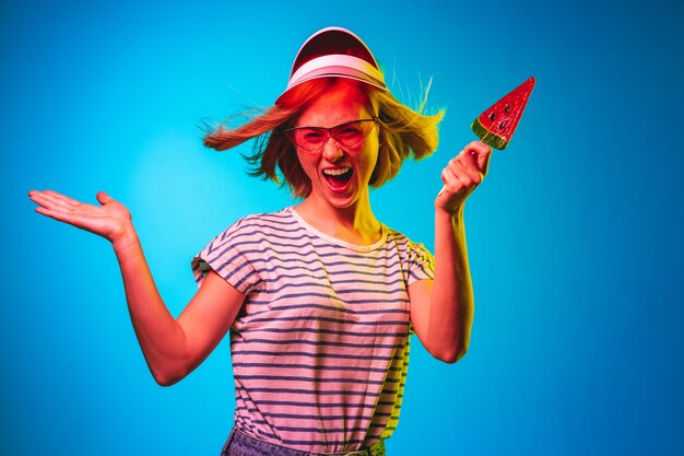 Beautiful female half-length portrait isolated on blue neon lights studio