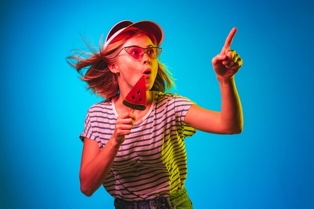 Beautiful female half-length portrait isolated on blue neon lights studio