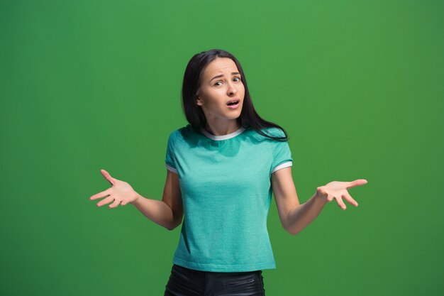 Beautiful female half-length portrait isolated on green