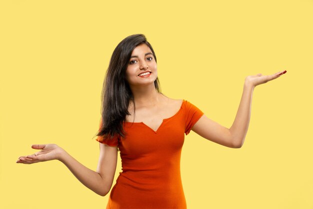 Beautiful female half-length portrait on yellow studio