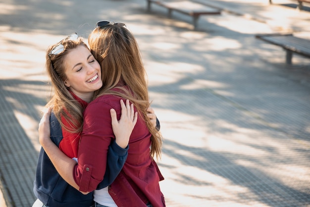 Beautiful female hugging on street