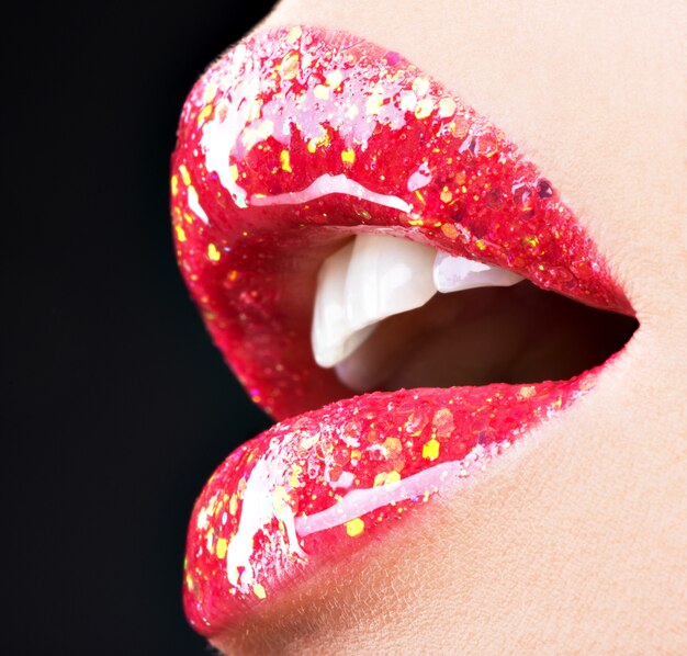 beautiful female lips with shiny red gloss lipstick