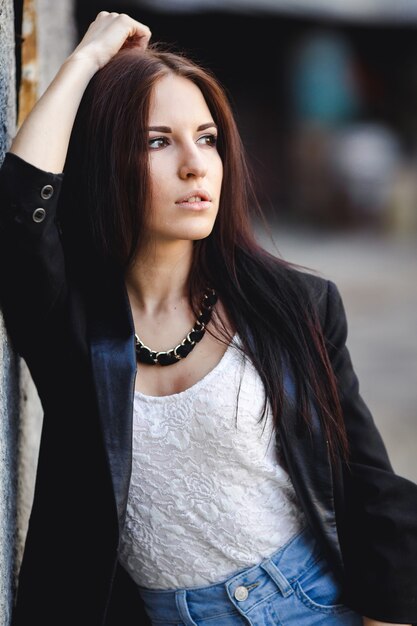 Beautiful female model posing against the wall