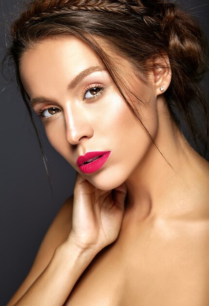 Beautiful female model with fresh daily makeup with red lips